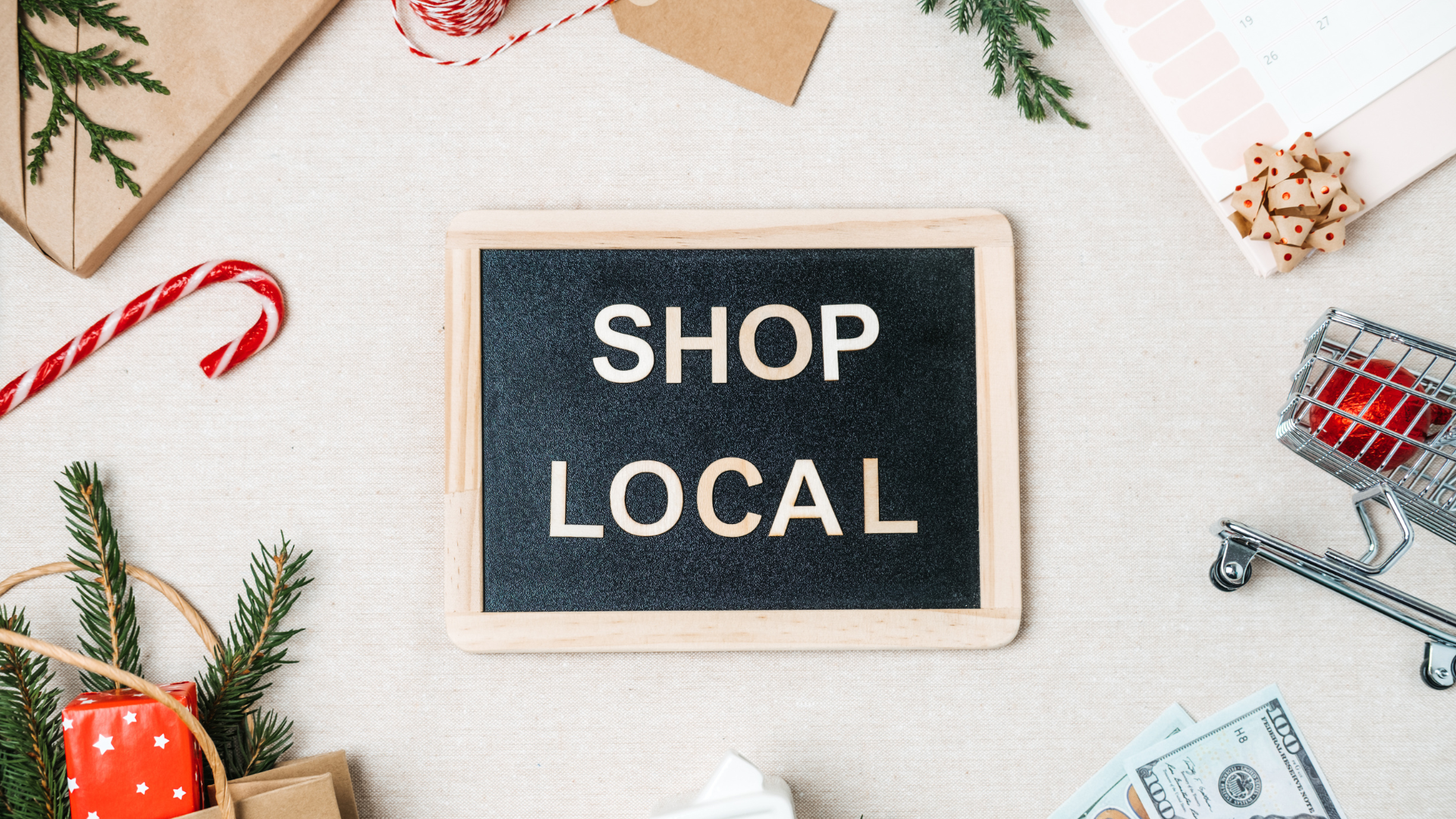 A sign that says Shop Local surrounded by holiday paraphernalia.