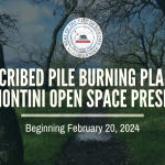 A photo of a trail with green grass, trees and puddles with a notice of prescribed burning February 2024 - April 2024 at the Montini Preserve.