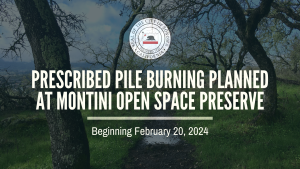A photo of a trail with green grass, trees and puddles with a notice of prescribed burning February 2024 - April 2024 at the Montini Preserve.