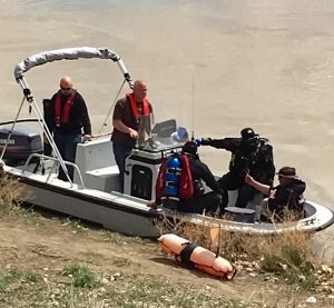 Search and recovery dive team in the boat on shore