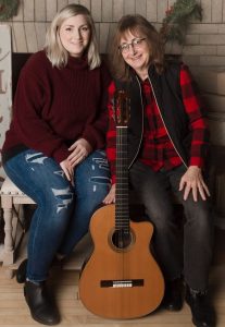 Two women with a guitar