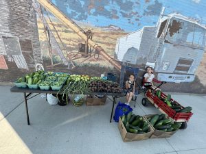 Kids with a table of produce