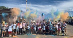 Crowd of people during a color run covered in paint