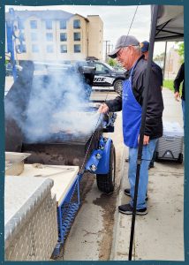 Man cooking burgers on a grill