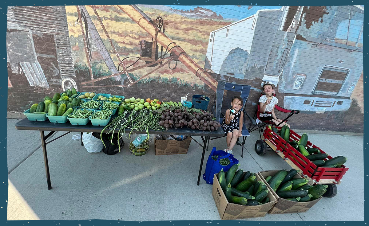 Kids with a table of produce