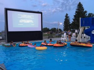 Kids watching a movie in a pool