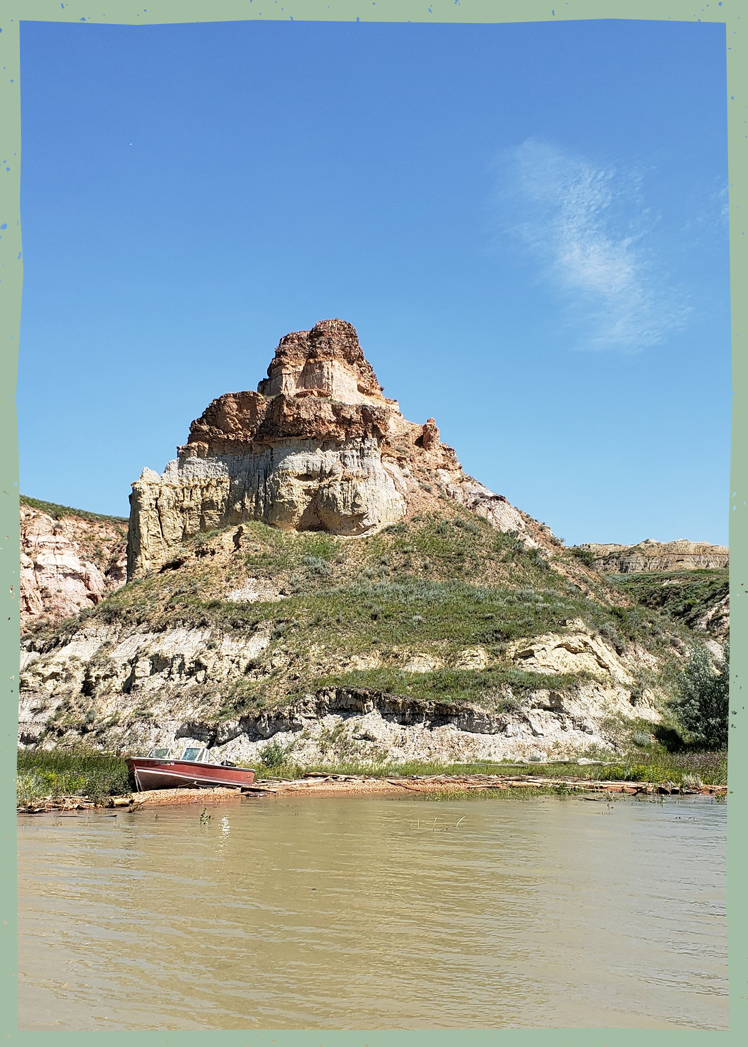 Land formation with a red boat on a lake