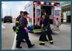 Paramedics carrying a person on a stretcher