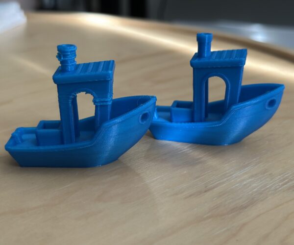 Two Benchy 3D Prints, one with issues with the cabin and smokestack and the other printed with minimal problems.