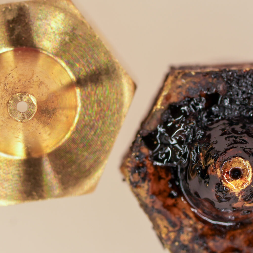 One new and one well used nozzle