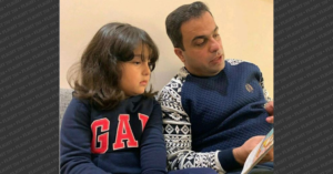 Amir Hossein Ovaysi reading a book to his daughter, Asal Ovaysi