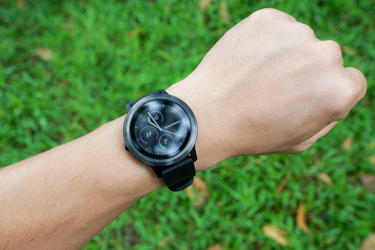 Smart fitness tracker on an athlete's wrist during a recovery workout