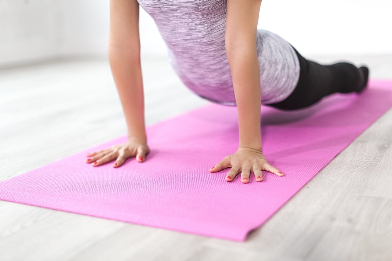An exercise mat set up on the floor for dynamic warm-ups