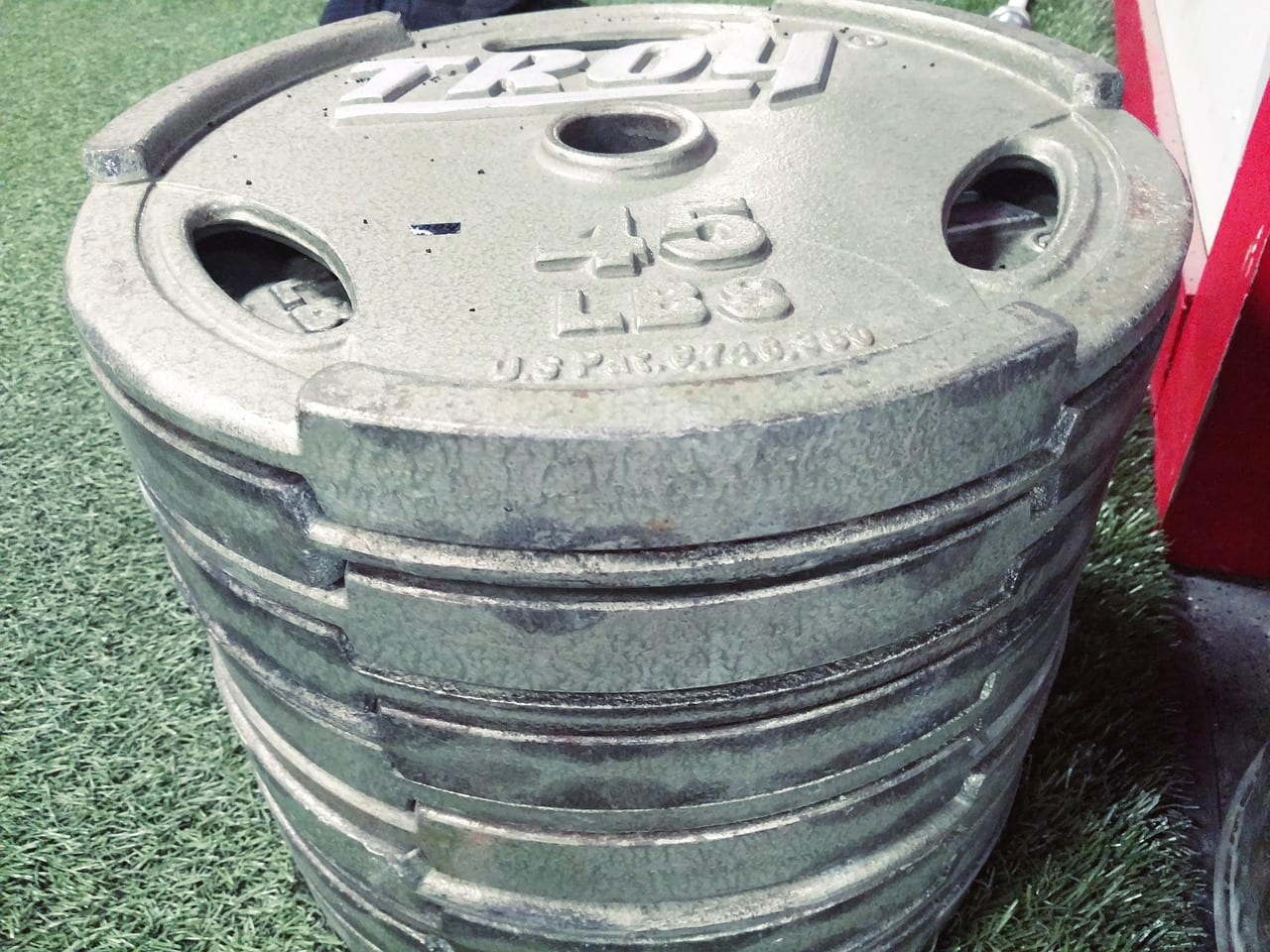 Barbell loaded with olympic weight plates on a lifting platform