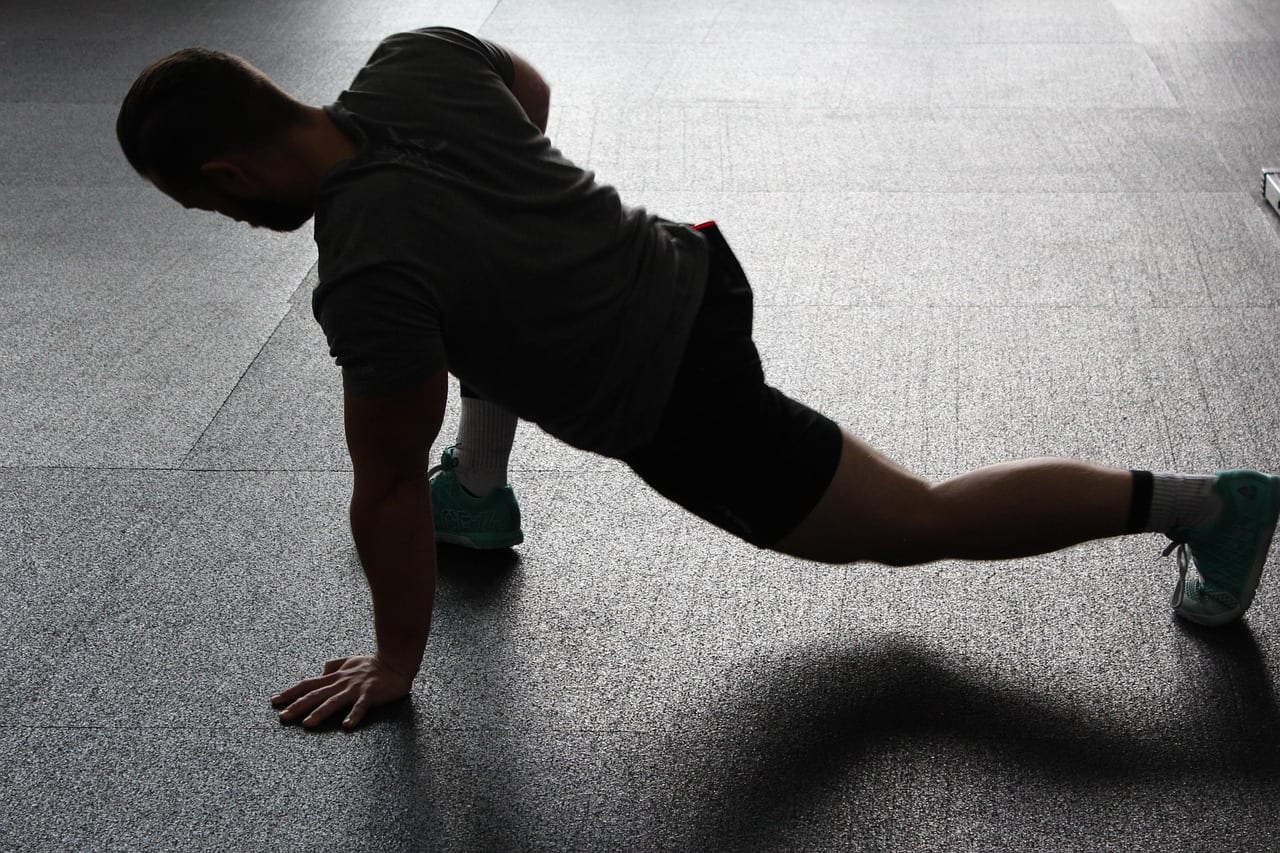 An athlete stretching their hamstrings with a flat neutral spine