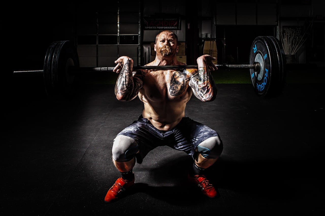 Heavy barbell loaded with weight plates in a gym setting