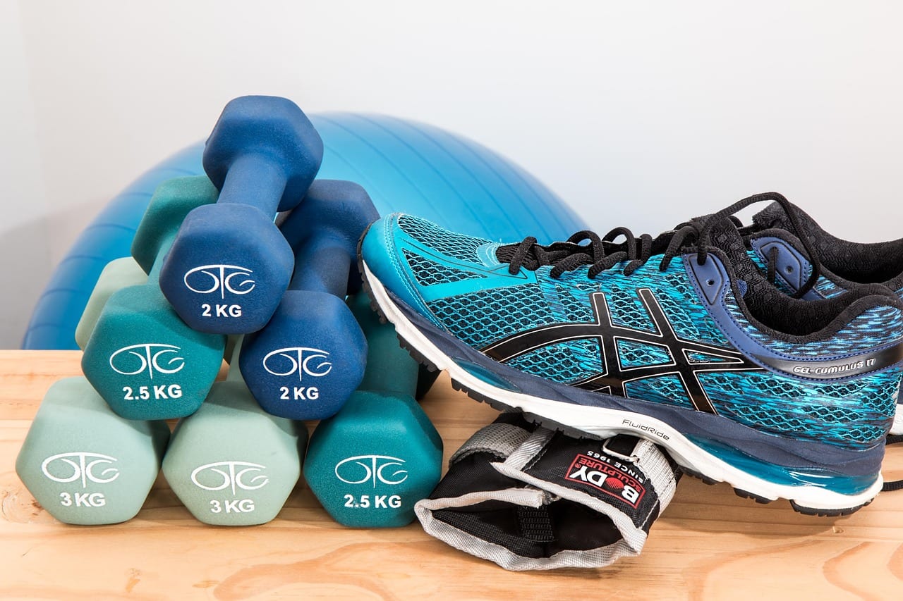 Athlete performing targeted upper body accessory exercises with dumbbells