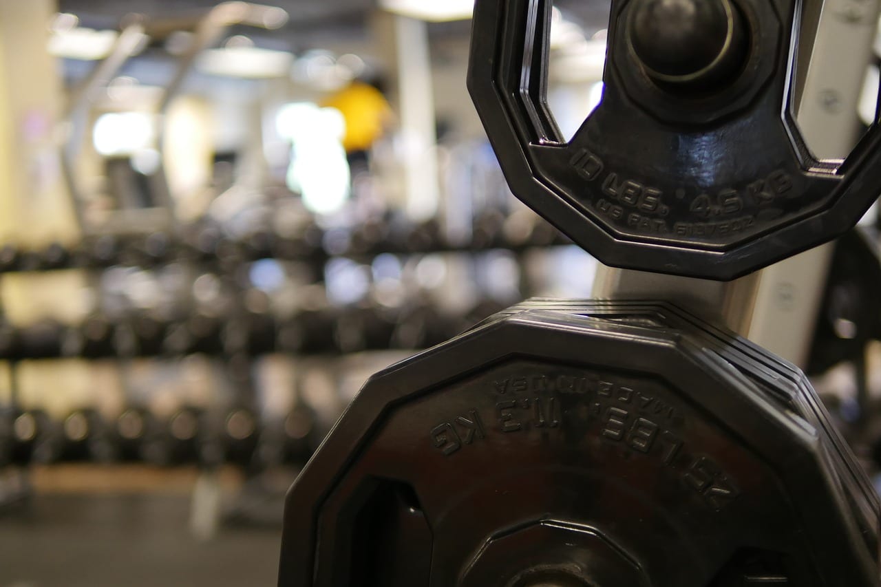 Row of cast iron kettlebells on a rubber gym floor