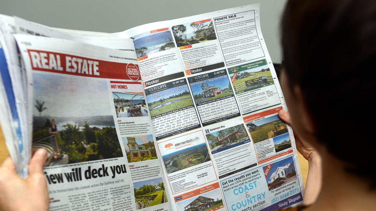 A woman looks at real estate advertising (file image)