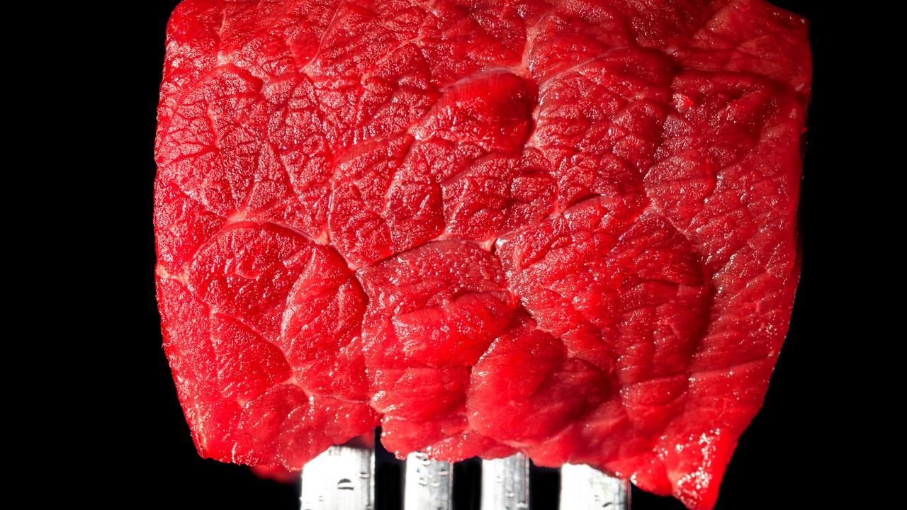 A piece of beef on a fork.