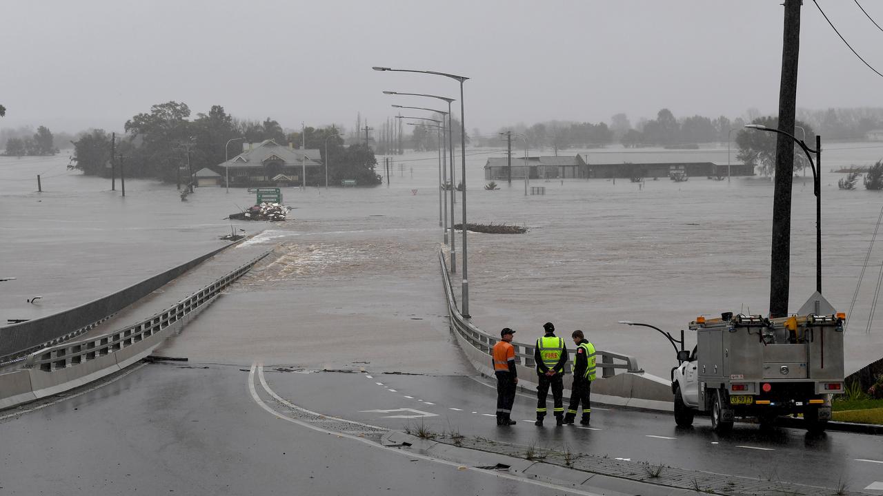 Emergency workers look amid flooding at Windsor, north west of Sydney