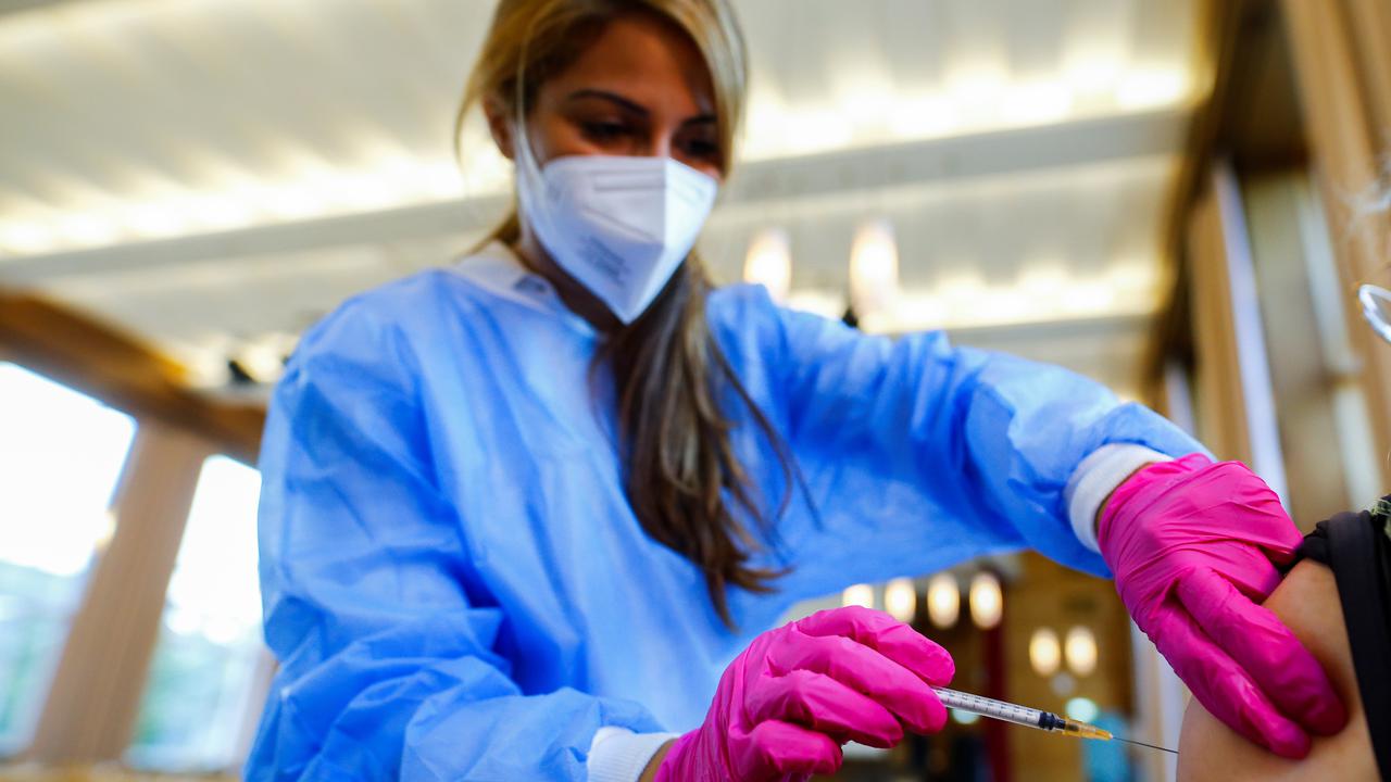 A medical worker administers a COVID-19 vaccine.