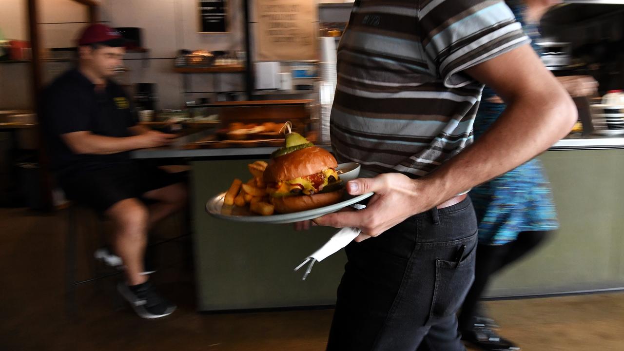An employee serving a plate of food at a cafe (file image)