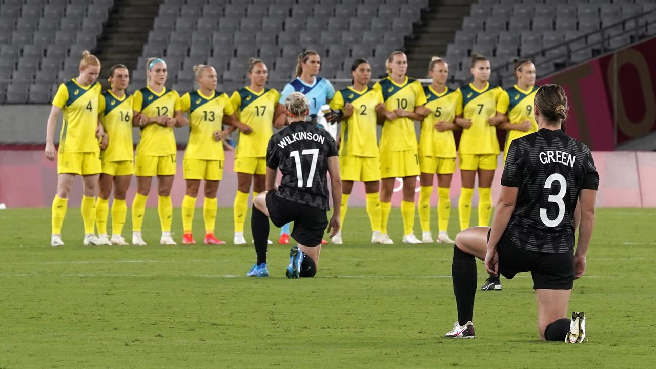 NZ players kneel before the women's soccer match against Australia.