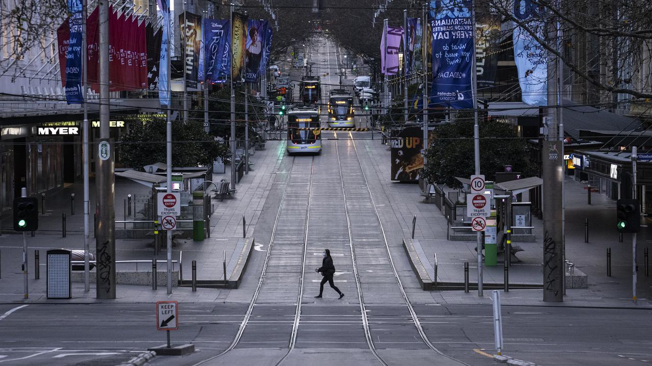 A person crosses a quiet Bourke Street in Melbourne