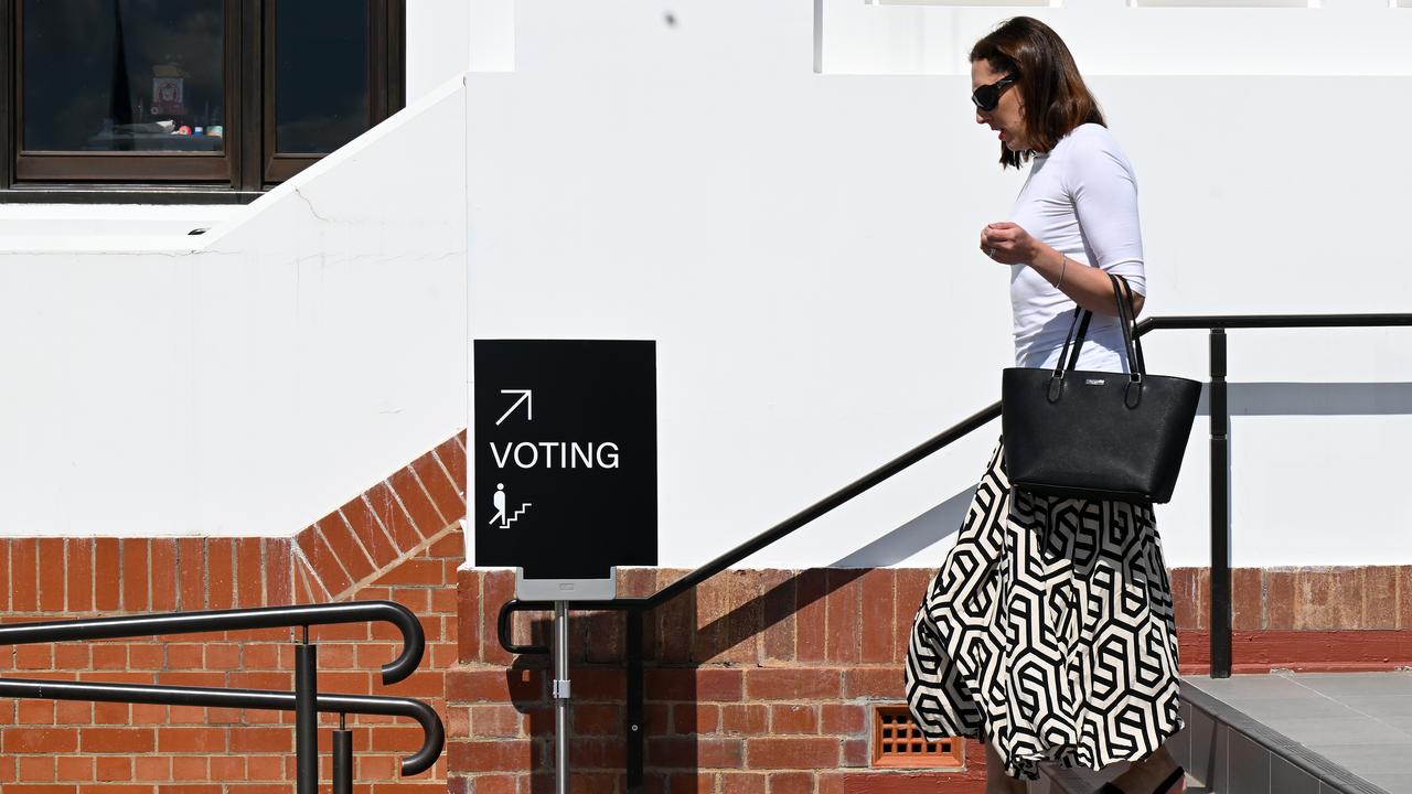 A woman leaves after casting her vote