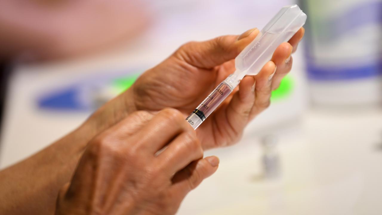 A healthcare worker preparing a Covid vaccination.