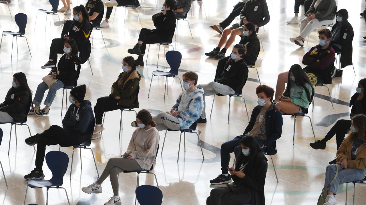 Students wait for COVID-19 vaccinations in Sydney.