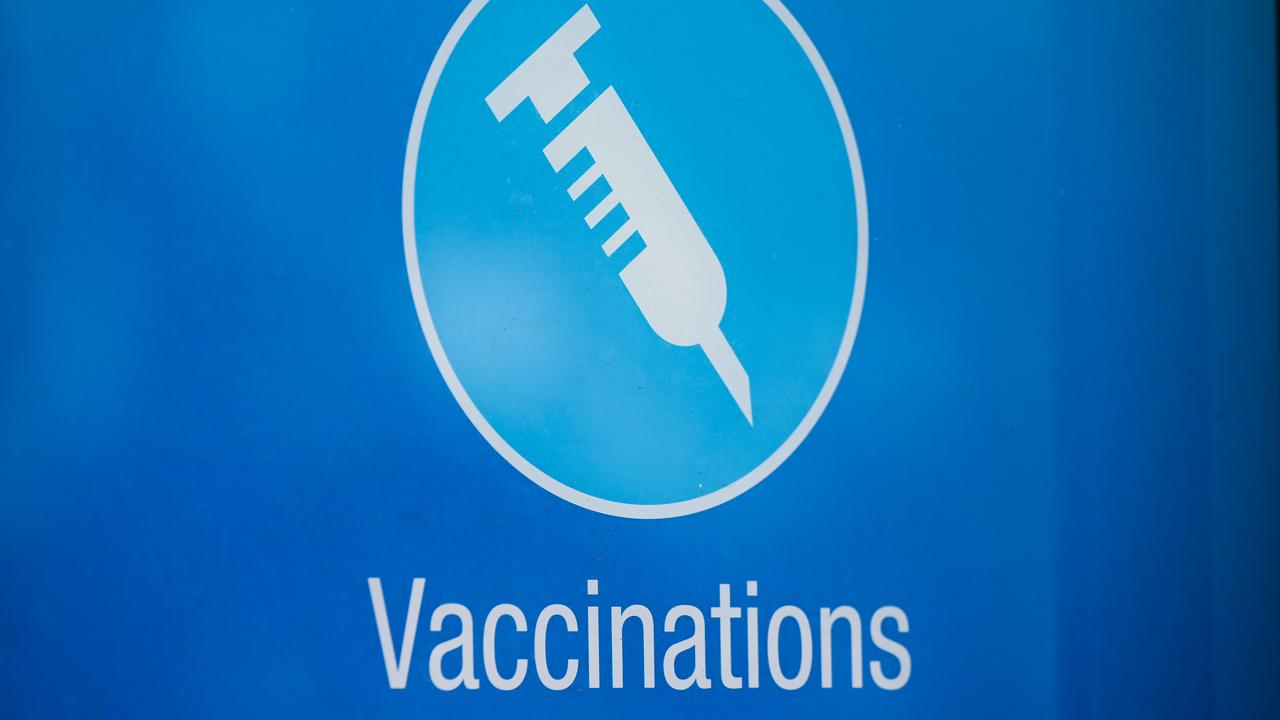 A sign advertising vaccinations a ta Canberra pharmacy.