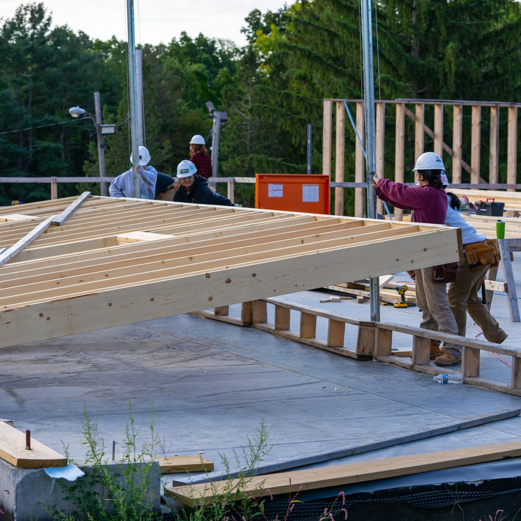 Estudantes de carpintaria sênior trabalhando na construção de uma nova parede no Larkin Cottage.