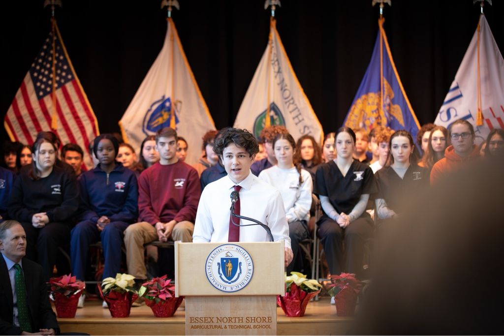 Senior Thomas Politano introduced Governor Baker. The poinsettias in the background were grown on our campus by our Horticulture students!