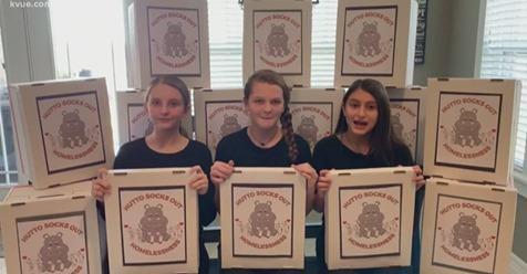 students holding sock boxes