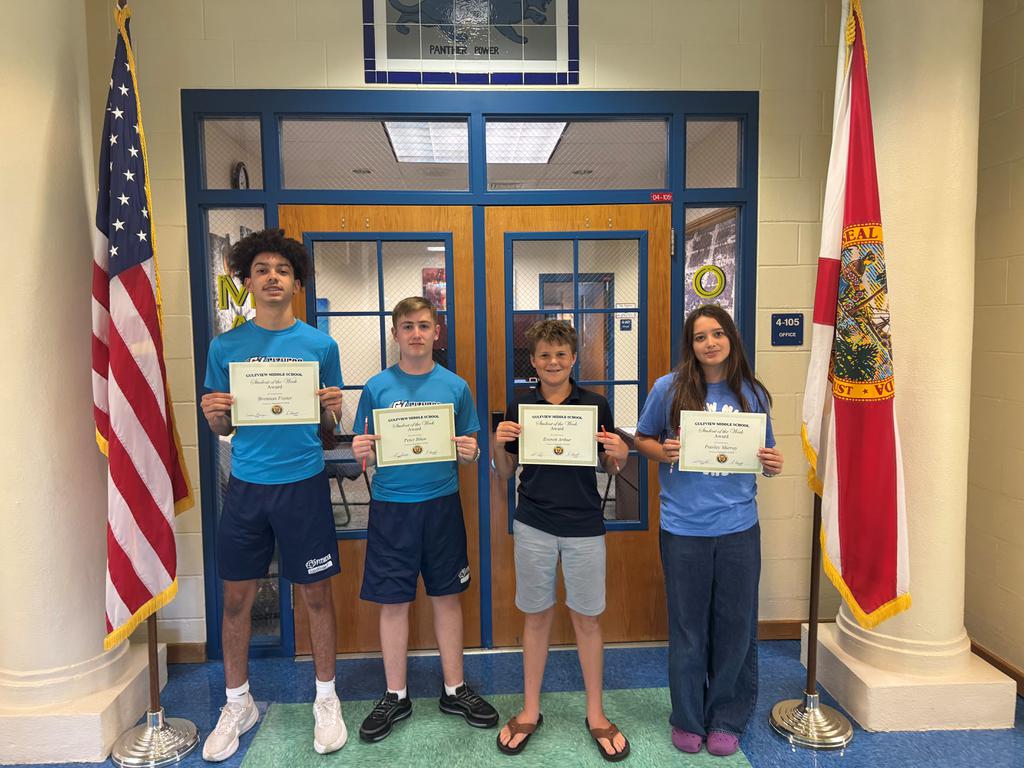 Students of the week holding their awards