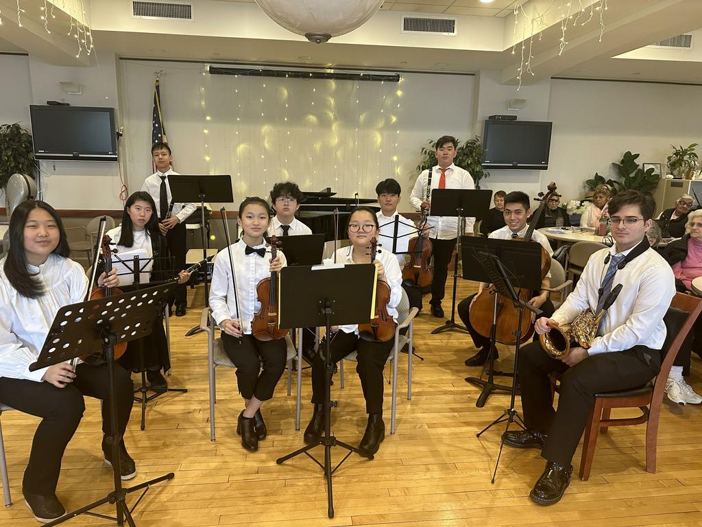 student musicians pose with instruments