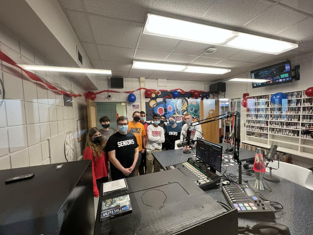 Students pose in the new radio station at the high school