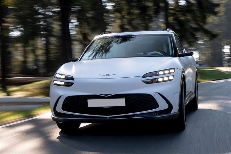 White Genesis Gv60 Estate driving on a road