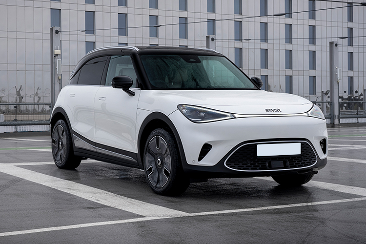 White Genesis Gv60 Estate driving on a road