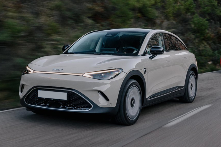 Grey Genesis Gv70 Electric Estate driving down a road