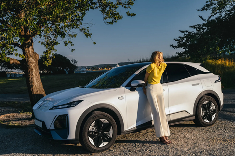 White Genesis Gv60 Estate driving on a road