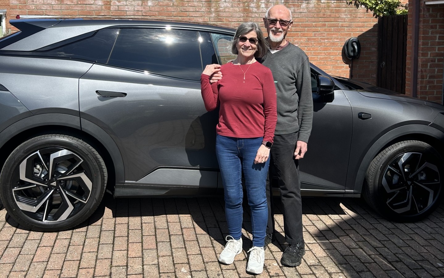 Robin and Amy stood in front of their grey Changan Deepal S07.