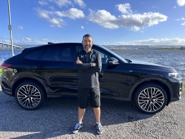 Dougie stood in front of his black Audi Q5.