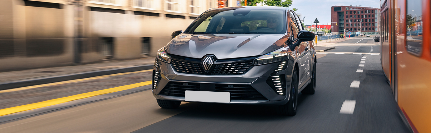 A Renault Clio driving down a road