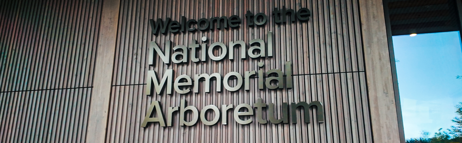 A sign that reads 'Welcome to the National Memorial Arboretum'.