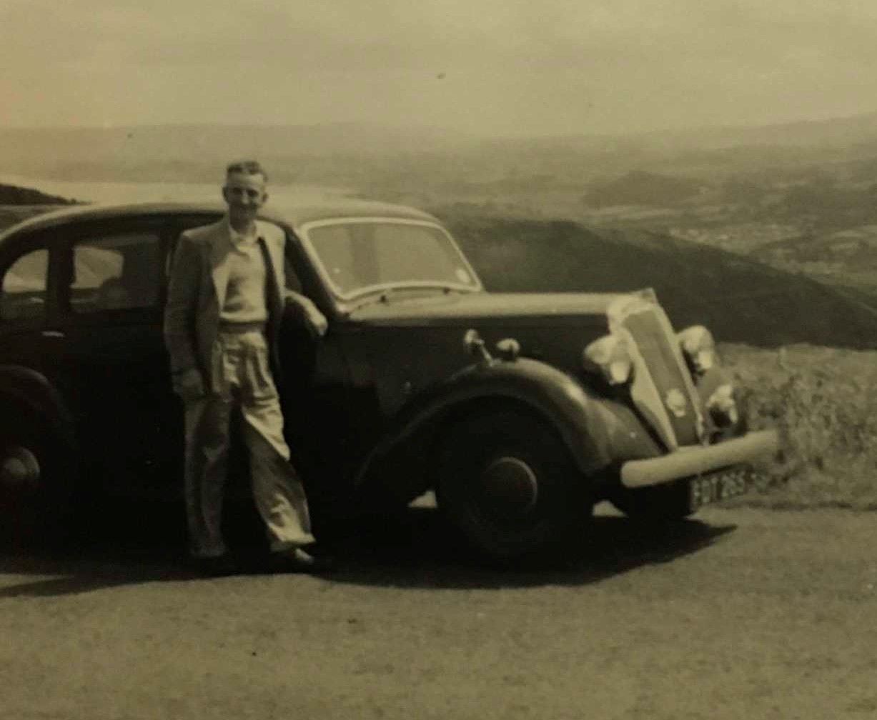 Renee's father stood beside their family car