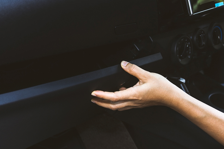Someone closing their glove compartment