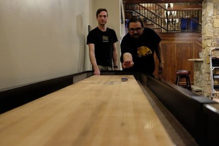 A photo of team members playing shuffleboard.